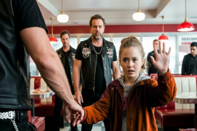 An 8-year-old girl looked across the restaurant and made a silent hand signal. Everyone missed it. Except five veterans in leather vests. They didn’t call police right away. They called a social worker, staged an accident, and bought enough time —to save her life.