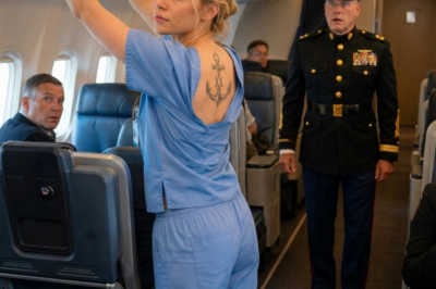 He laughed at her scrubs in first class. She didn’t say a word. Then a Marine commander saw the tattoo on her shoulder blade and froze. Turns out the nurse was the only female survivor of an off‑the‑books black ops unit. Silence isn’t weakness. Sometimes it’s the loudest thing in the room.