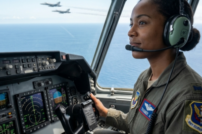 **”The pilot collapsed at 38,000 feet. 300 lives in freefall. Then a quiet woman in seat 14A walked to the cockpit, spoke her old call sign—and two F-22s scrambled. Turns out, heroes don’t always wear uniforms. Some just never forgot how to fly.”**