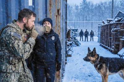 A Navy SEAL pulled over at an abandoned mill in a blizzard. His K9 went stiff. Then he heard two voices calmly discussing how a female cop wouldn’t make it out alive before morning. Headlights appeared through the snow. A patrol car. Alone. He had seconds to decide.